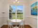 Cozy dining nook with a round table and scenic golf course view through a large window at 1844 Wood Stork Dr., Conway, SC 29526