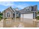 Beautiful blue home featuring a two-car garage, stone accents, and manicured landscaping at 1844 Wood Stork Dr., Conway, SC 29526