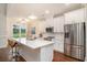 Bright open kitchen with white cabinets, quartz countertops, pendant lighting and stainless appliances at 1844 Wood Stork Dr., Conway, SC 29526