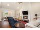 Cozy living room with a fireplace, hardwood flooring, and an open view to the dining area at 1844 Wood Stork Dr., Conway, SC 29526