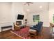 Bright living room featuring a fireplace, hardwood floors, and comfortable seating arrangement at 1844 Wood Stork Dr., Conway, SC 29526