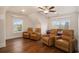 A cozy living room with hardwood floors and four leather recliners under a ceiling fan at 1844 Wood Stork Dr., Conway, SC 29526