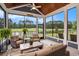 Beautiful screened porch with outdoor furniture and scenic views of the golf course and pond at 1844 Wood Stork Dr., Conway, SC 29526