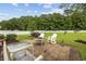 Enjoy outdoor living on this brick patio with fire pit, grill, and a spacious fenced-in backyard at 195 Black Pepper Loop, Little River, SC 29566