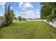 Large, private backyard featuring a green lawn and white picket fence at 195 Black Pepper Loop, Little River, SC 29566
