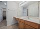 Bathroom with a large mirror, wood vanity, and vinyl flooring at 195 Black Pepper Loop, Little River, SC 29566