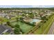 Aerial view of community featuring a pool, tennis courts, and well-maintained landscaping at 195 Black Pepper Loop, Little River, SC 29566