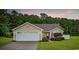 Charming single-story home with attached garage, well-maintained lawn, and mature landscaping at 195 Black Pepper Loop, Little River, SC 29566