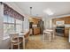 Bright kitchen with stainless steel appliances, oak cabinets, a dining table, and ample natural light at 195 Black Pepper Loop, Little River, SC 29566