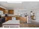 Open-concept kitchen with wood cabinets, a breakfast bar, and a clear view into the living room at 195 Black Pepper Loop, Little River, SC 29566