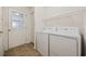Well-lit laundry room equipped with a washer, dryer, and storage shelves for organization at 195 Black Pepper Loop, Little River, SC 29566