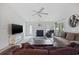 Comfortable living room with a ceiling fan, fireplace, and sliding glass doors to the backyard at 195 Black Pepper Loop, Little River, SC 29566