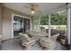 Enclosed patio offering a cozy outdoor retreat with a stylish wicker furniture set at 195 Black Pepper Loop, Little River, SC 29566