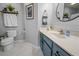Updated bathroom with blue vanity, white walls, and decorative accents create a charming space at 1984 Green Fern Ln. # 1984, Myrtle Beach, SC 29579