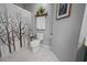 Cozy bathroom with stylish decor including a white-framed picture, tree-themed shower curtain and open storage at 1984 Green Fern Ln. # 1984, Myrtle Beach, SC 29579