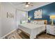 Cozy bedroom featuring wood-look floors, calming blue accent wall and abundant natural light at 1984 Green Fern Ln. # 1984, Myrtle Beach, SC 29579