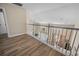 View of the hallway with natural light and hardwood floors overlooking the living room and dining area at 1984 Green Fern Ln. # 1984, Myrtle Beach, SC 29579