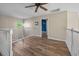 Upstairs hallway featuring wood-look floors, white railings and arched window with view at 1984 Green Fern Ln. # 1984, Myrtle Beach, SC 29579