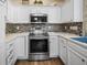Well-equipped kitchen with stainless steel appliances, tile backsplash, bright lighting, and plenty of cabinet space at 1984 Green Fern Ln. # 1984, Myrtle Beach, SC 29579
