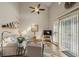 Well-lit living room featuring wood-look floors, a ceiling fan, and sliding glass doors at 1984 Green Fern Ln. # 1984, Myrtle Beach, SC 29579
