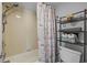 Bathroom featuring a decorative shower curtain and shelving offering extra storage at 2001 S Ocean Blvd. # 1405, Myrtle Beach, SC 29577