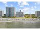 Beautiful view of a beach, showing sandy shores and crystal-blue water and surrounding buildings at 2001 S Ocean Blvd. # 1405, Myrtle Beach, SC 29577