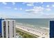 Expansive ocean view from above with a beach, pool, and high rise in view below at 2001 S Ocean Blvd. # 1405, Myrtle Beach, SC 29577