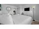 Bright bedroom with a comfy bed, TV, and a peek into the adjacent kitchen, providing a cozy and convenient space at 2001 S Ocean Blvd. # 1405, Myrtle Beach, SC 29577