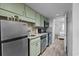 Efficient kitchen featuring stainless steel appliances, granite countertops, and green cabinets for a modern touch at 2001 S Ocean Blvd. # 1405, Myrtle Beach, SC 29577
