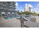 Inviting outdoor pool area with seating and a partial view of building at 2001 S Ocean Blvd. # 1405, Myrtle Beach, SC 29577
