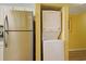 Stackable washer and dryer next to a stainless steel refrigerator at 2007 S Ocean Blvd. # 1403, Myrtle Beach, SC 29577