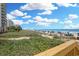 Scenic beach view from wooden walkway, showcasing lush greenery and oceanfront at 2007 S Ocean Blvd. # 1403, Myrtle Beach, SC 29577