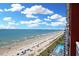 Oceanfront view featuring a beach and pool, with bright blue skies and white clouds at 2007 S Ocean Blvd. # 1403, Myrtle Beach, SC 29577