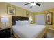 Bedroom features a king-sized bed, a ceiling fan, and matching bedside lamps at 2007 S Ocean Blvd. # 1403, Myrtle Beach, SC 29577