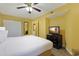 Bedroom with a flat-screen TV and closet doors on a yellow-walled room at 2007 S Ocean Blvd. # 1403, Myrtle Beach, SC 29577