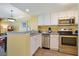 Modern kitchen features stainless steel appliances, white cabinetry, and a breakfast bar, ideal for meal preparation and serving at 2007 S Ocean Blvd. # 1403, Myrtle Beach, SC 29577