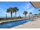 Outdoor pool overlooking the ocean is surrounded by palm trees and provides a refreshing escape at 2007 S Ocean Blvd. # 1403, Myrtle Beach, SC 29577
