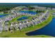 Aerial view of the neighborhood featuring a lake, lush green lawns and mature trees at 2106 Ainsley Dr., Little River, SC 29566