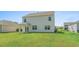 Exterior of home showcasing the backyard, patio, and lush lawn at 2106 Ainsley Dr., Little River, SC 29566