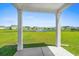 Scenic backyard view of a pond with a fountain from under the covered patio at 2106 Ainsley Dr., Little River, SC 29566