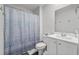 Clean bathroom featuring a blue patterned shower curtain, a toilet, and a sink at 2106 Ainsley Dr., Little River, SC 29566