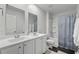 Clean bathroom featuring double sinks with white cabinets, a toilet, and a shower-tub combo at 2106 Ainsley Dr., Little River, SC 29566