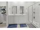 Bathroom featuring double sinks, white cabinets, walk in shower, and blue floor mats at 2106 Ainsley Dr., Little River, SC 29566