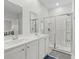 Modern bathroom with double sinks, a glass-enclosed shower, and white cabinetry at 2106 Ainsley Dr., Little River, SC 29566