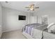 This bedroom features a ceiling fan, television, and an ensuite bathroom at 2106 Ainsley Dr., Little River, SC 29566