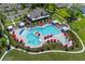 Overhead shot of community pool featuring a clubhouse, pool, and many lounge chairs at 2106 Ainsley Dr., Little River, SC 29566