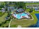 Aerial view of the community pool with cabanas, lounge chairs and lush landscaping at 2106 Ainsley Dr., Little River, SC 29566