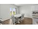 Bright dining area with white table and decorative chairs that is open to the kitchen with granite countertops at 2106 Ainsley Dr., Little River, SC 29566