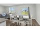 Bright dining area featuring a white table, decorative chairs, and a sliding glass door with views of the water at 2106 Ainsley Dr., Little River, SC 29566