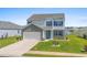 Charming two-story home with blue shutters and a well-manicured lawn and pond view at 2106 Ainsley Dr., Little River, SC 29566